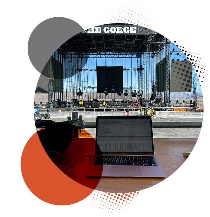 View from behind a laptop at the Gorge Amphitheater as the stage is being constructed.