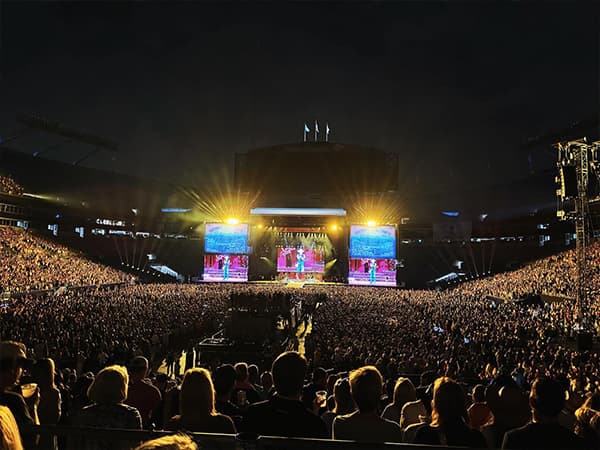 A packed audience watching a Kenney Chesney concert.