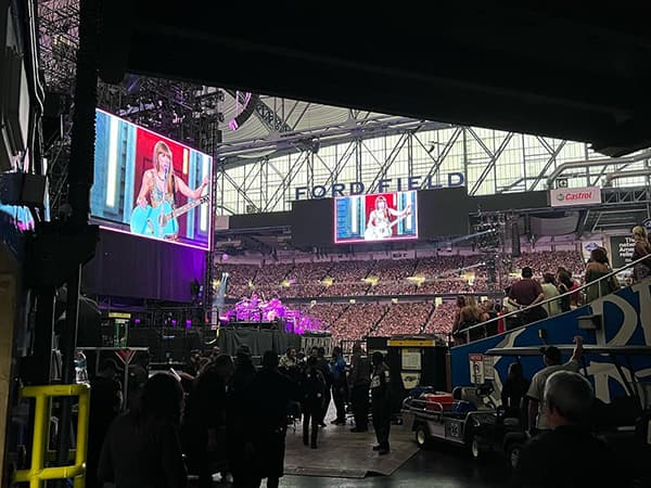 Event staff watching Taylor Swift during her concert at Ford Field